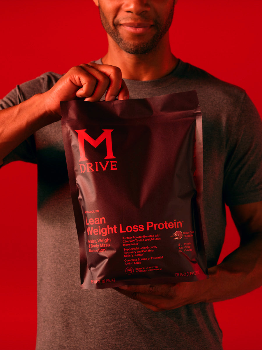 Man holding pouch of M Drive Lean weight loss protein