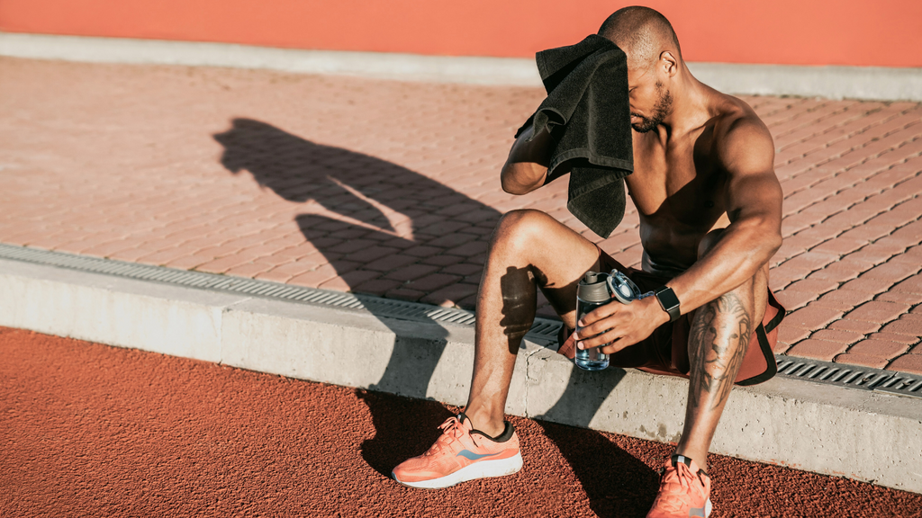 Man wiping face after workout