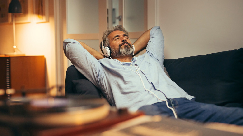 Man relaxing on couch with headphones