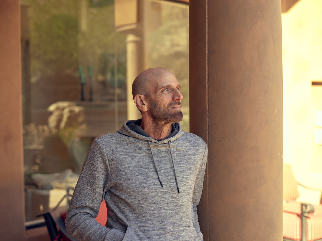 Boost cortisol levels with sunlight - man standing outside in sun