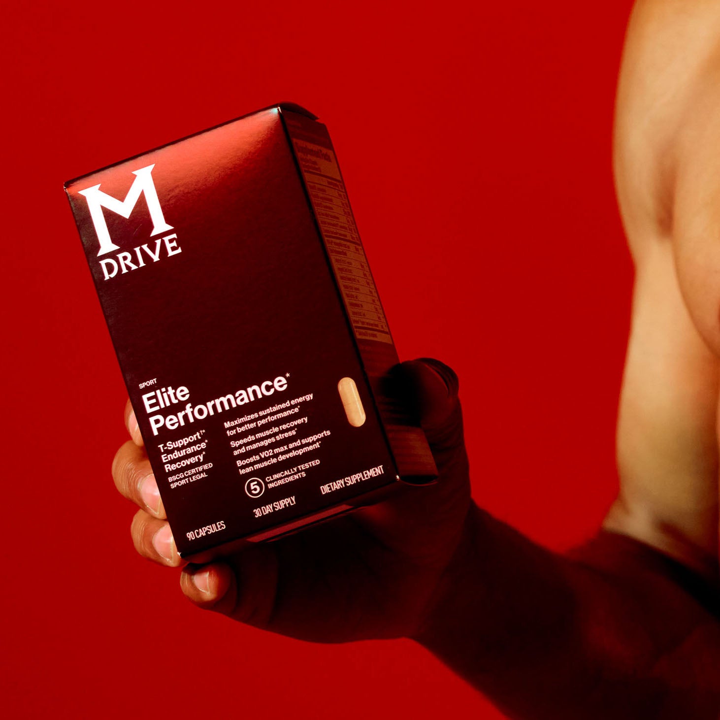 Man holding box of M Drive Elite supplement