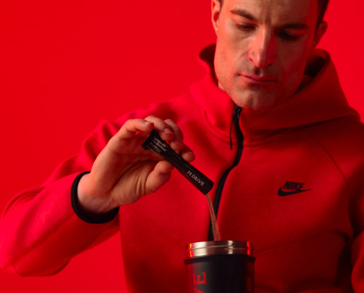 Man pouring M Drive Accelerate Pre-workout into a shaker