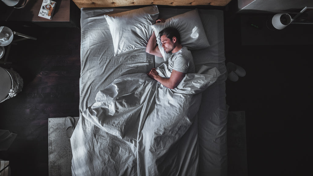 Man in bed. How Much Sleep Do You Need To Lose Weight?