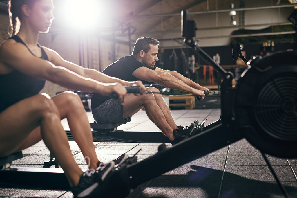 Man and woman on a rowing machine | Burning fat exercises.