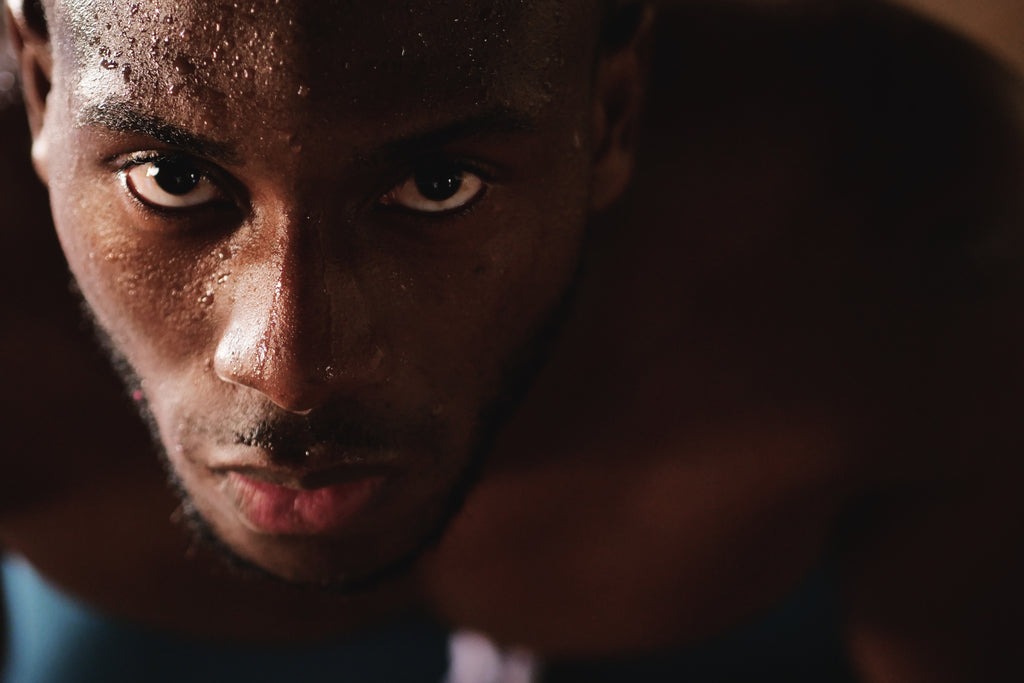 Man's sweaty face doing high intensity training