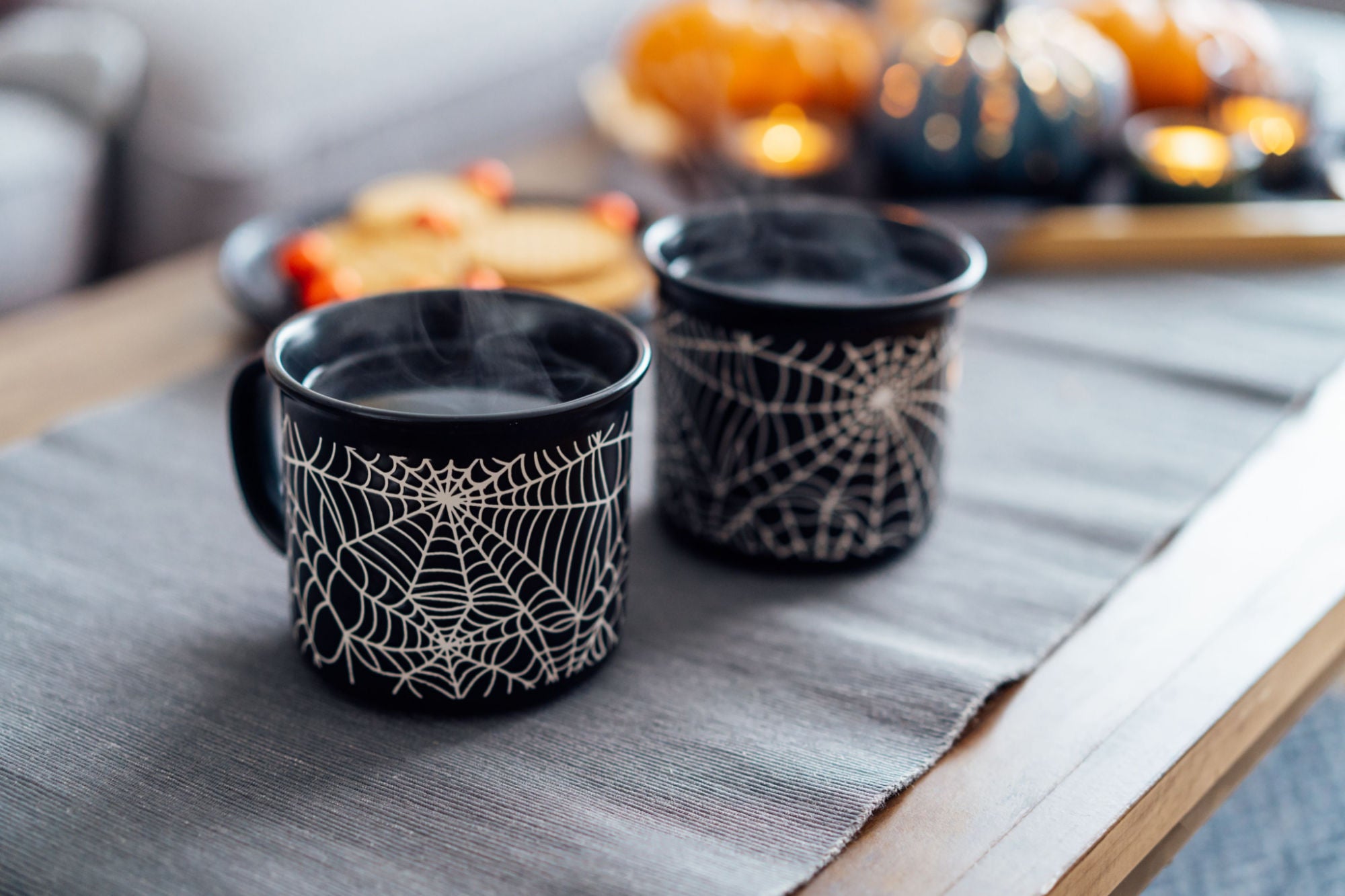 spiderweb coffee mugs on coffee table