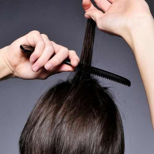 backcombing hair to create volume