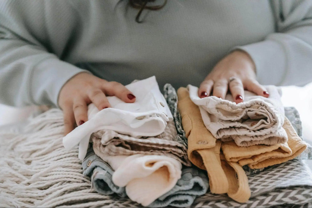 A women folding childrens clothes