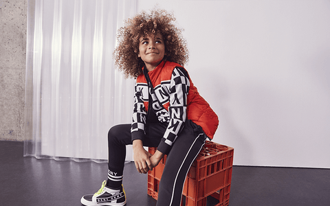 fashion kid with afro on stool urban outfit style