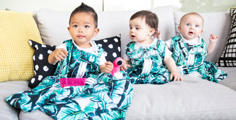 babies on couch all wearing milimili palm print sleep sacks