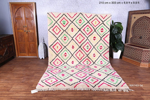 white rug with neon pink and green diamond design