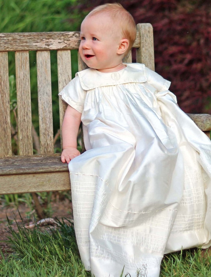 baby in christening gown