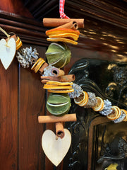 Hanging dried fruit garland with wooden heart at the end.