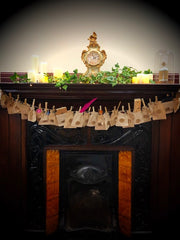 Decorated fireplace with festive decor on the mantlepiece and filled, numbered pouches hung below 