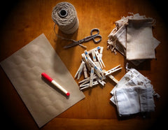 Supplies for crafting - plain stickers, pen, string, pegs, fabric pouches or envelopes and scissors