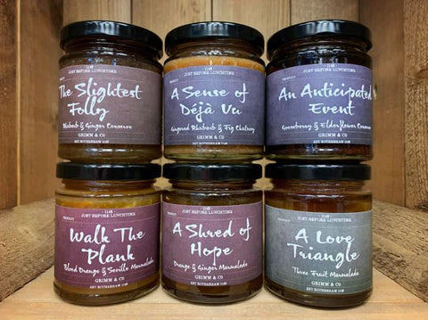 Image showing the collection of six jams, chutneys and marmalades each with a different flavour and name alluding to elements of a story such as A Love Triangle, Walk the Plank and A Sense of De Ja Vu.