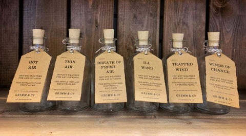 Image of 6 empty bottles with kraft labels and names such as Trapped Wind, Hot Air and Breath of Fresh Air.