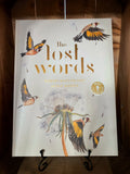 Image of the hardback table book Lost Words with illustrations of wild and woodland animals and insects on the cover.