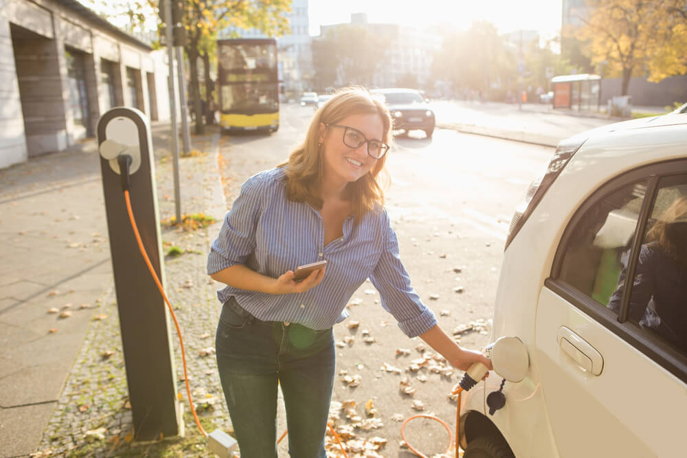 woman charging electric car