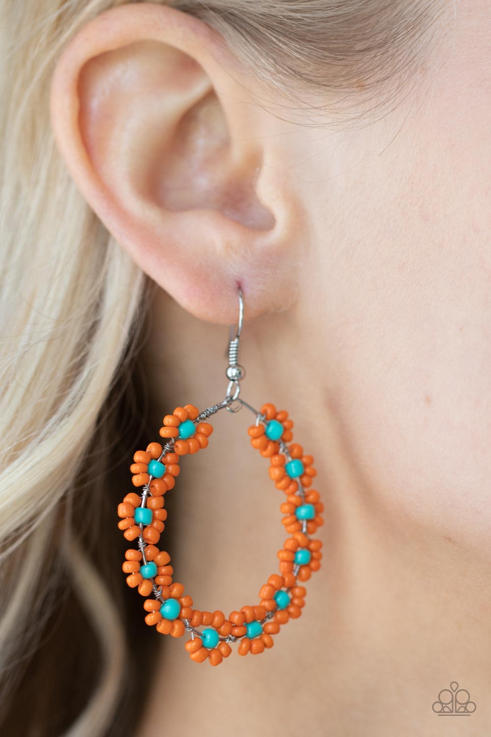Festively Flower Child - Orange Seed Bead Earrings dotted with turquoise beaded centers, a dainty collection of orange seed beaded floral frames are threaded along a wire hoop for a fabulous floral fashion. Earring attaches to a standard fishhook fitting.  Sold as one pair of earrings.  Paparazzi Jewelry is lead and nickel free so it's perfect for sensitive skin too!