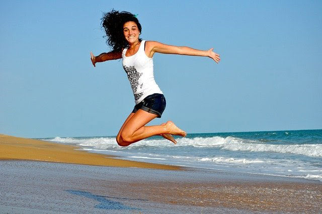 healthy  woman jumping at beach