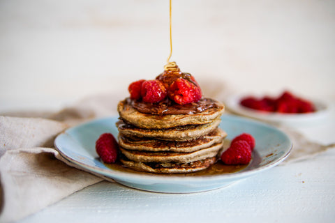 poring honey on pancakes