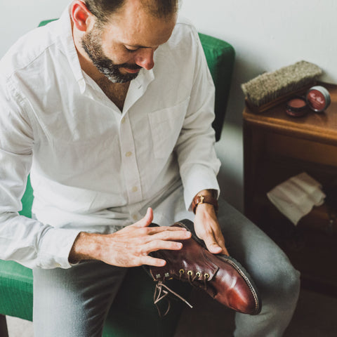 Pure Polish Products Owner Andy Vaughn polishes a pair of red boots with Burgundy Cream Polish