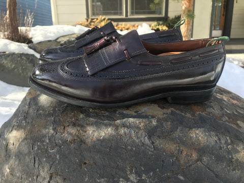 Beautiful Allen Edmonds Arlington Loafers on a rock in the snow turned sideways