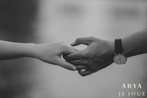 Two people holding hands in black and white