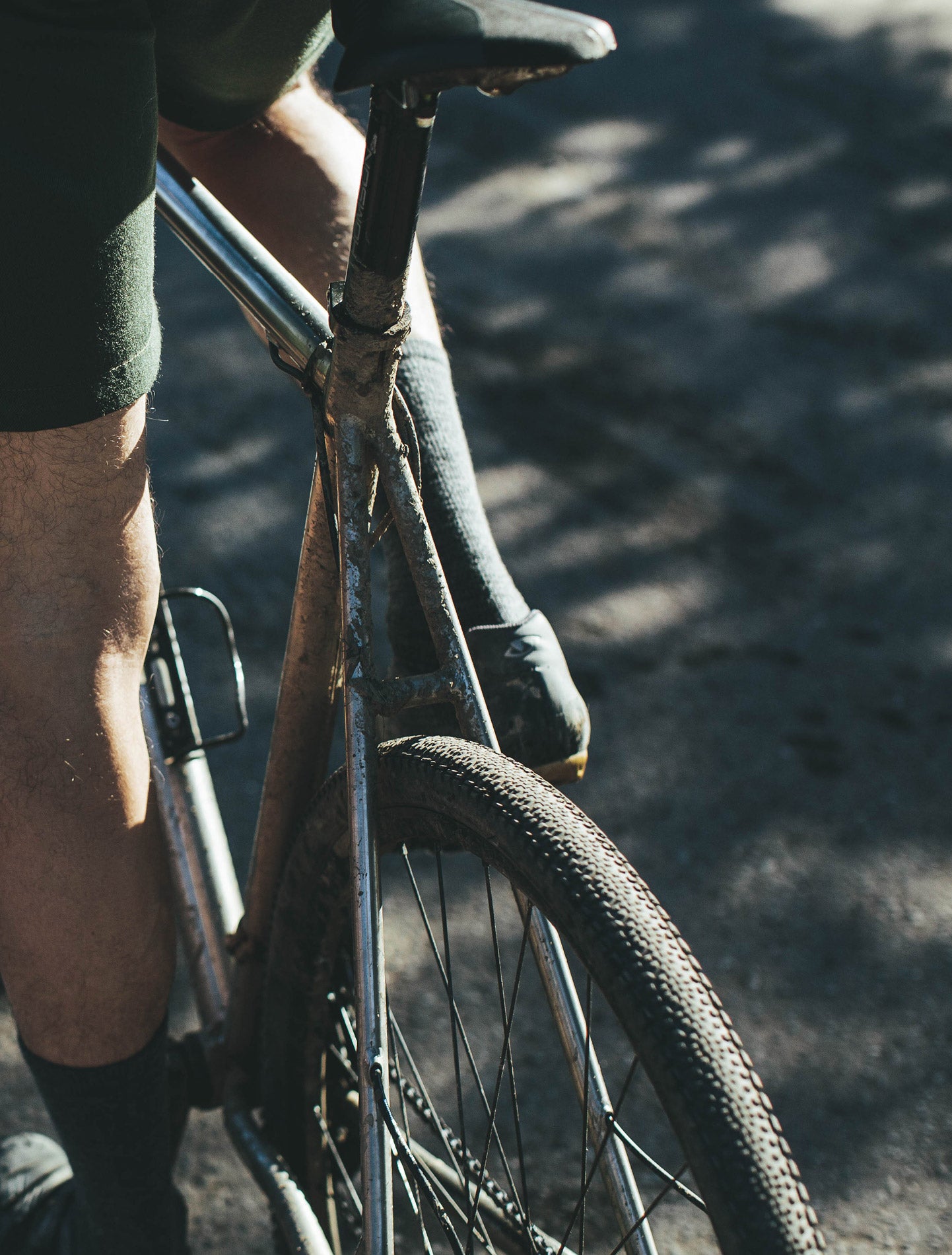 A full-spread of powerful legs pushing pedals on a bicycle.