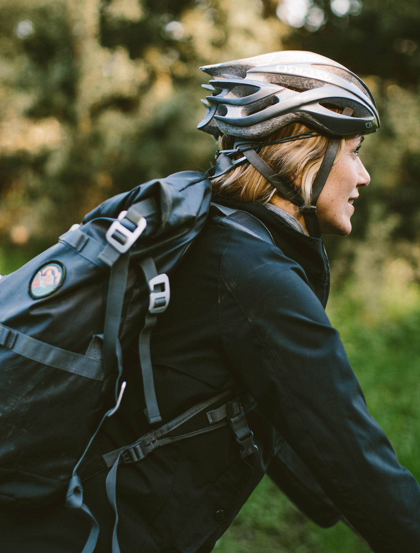 A woman rides a bike with a smile on, along with some sweet CIVIC apparel.