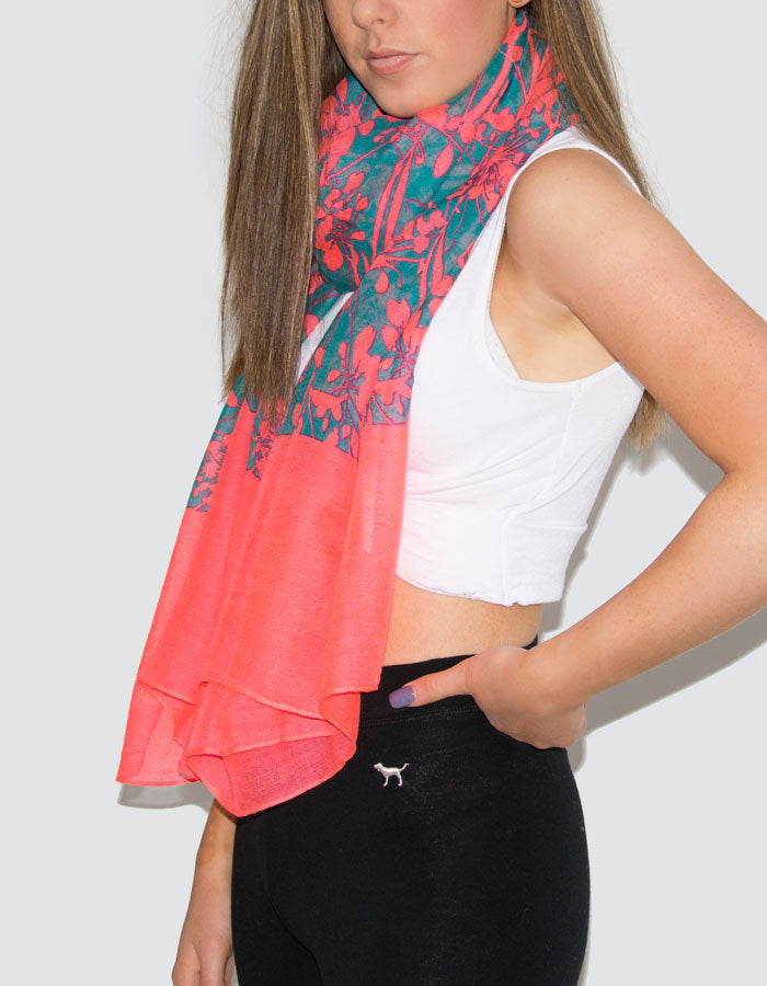 A photograph showing a neon coral flowers scarf