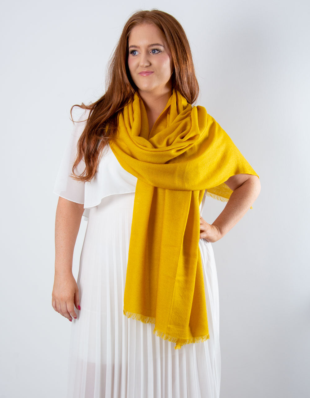 an image showing a cashmere wedding pashmina in mustard