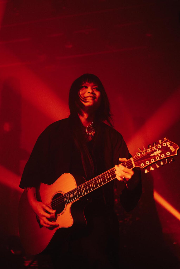 Kai from The Sisters of Mercy playing a 12-string acoustic guitar