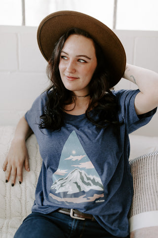 Woman wearing blue mountain t-shirt short sleeved with mount rainier 