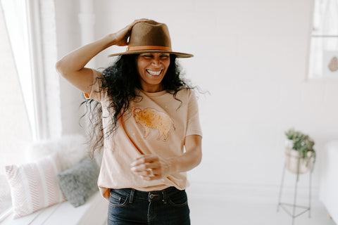 Woman wearing t-shirt with bison/buffalo and wool hat