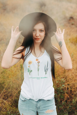 Graphic Style Tank top with Pacific Northwest Wildflowers on the front. Cute Wide Brim Hat. Field. Summer time. Golden Hour. Wearing white tank tops with jeans and jeans shorts. Summer time. Wenatchee, Washington. PNW Style. Pacific Northwest. Mountains. Mountain Style.