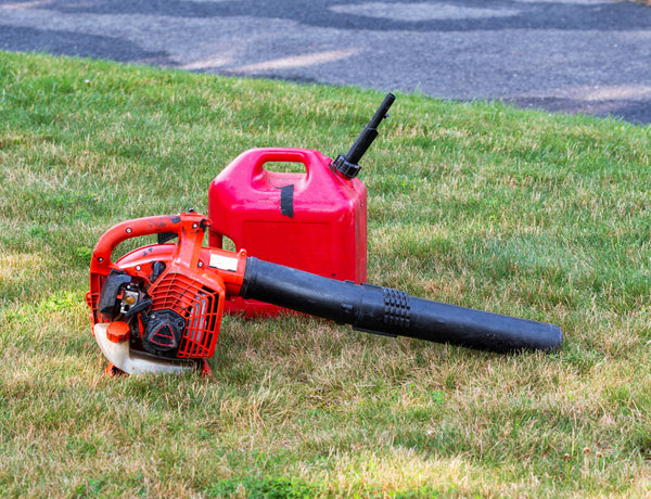 Leaf blower and gas can on grass lawn. Schröder USA