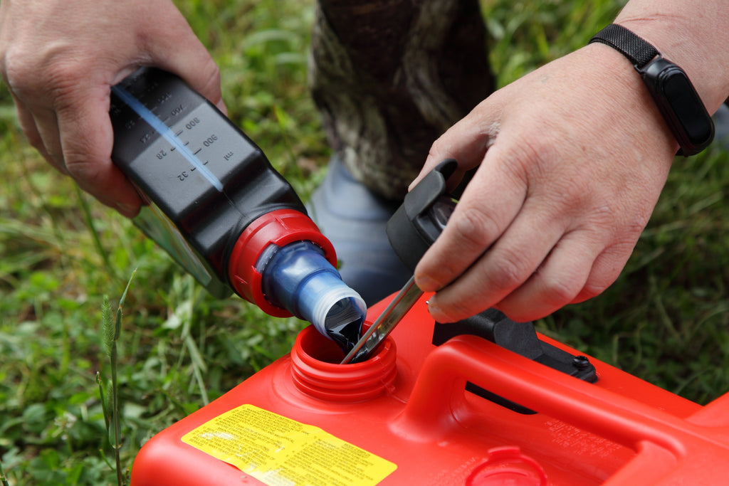 Man measuring the proper gas-oil mix for leaf blower. Schröder USA