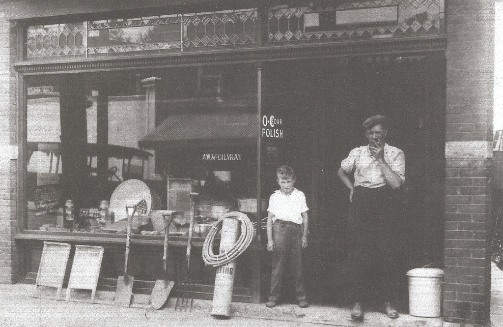 Claude and Watt McGilvray in front of their business at 3095 Dundas St. W in 1920