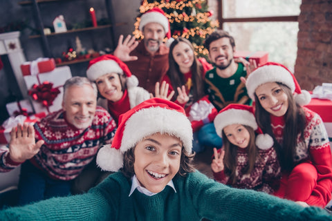 Self-portrait of attractive cheerful family waving hello greetings having fun christmas gathering eve advent party time at home indoors