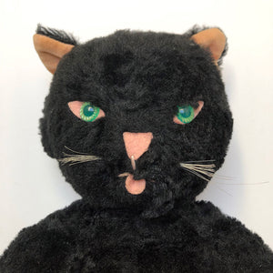 plush black cat with green eyes