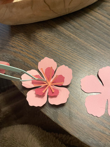 Hibiscus paper flower- using tweezers to keep flower shape while glueing