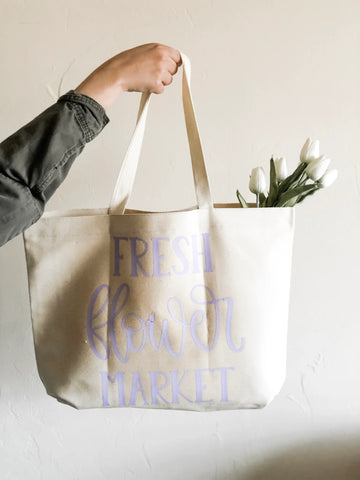 "Fresh Flower Market" quote on a canvas tote bag with flowers in the bag