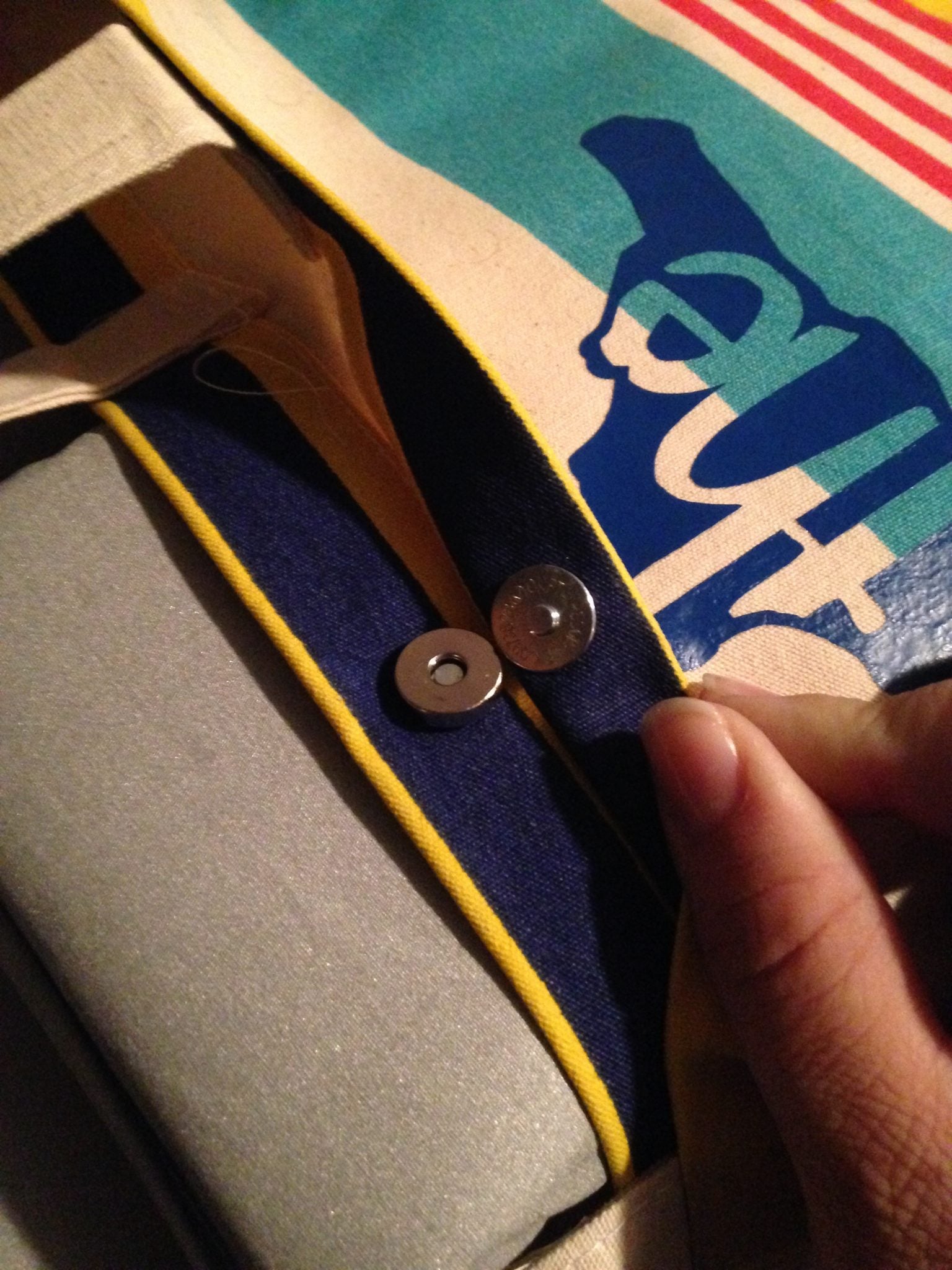 A magnetic button might just keep you from heat pressing your design all the way. Use a pressing pillow to help!