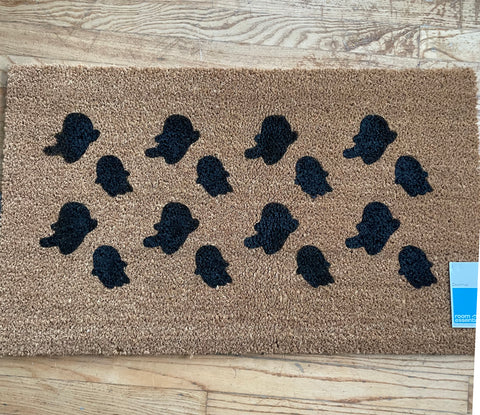 Black painted ghosts on door mat