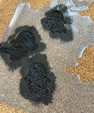 Black painted ghosts using Cricut Stencil vinyl on door mat