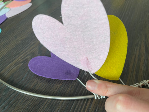 using a scrap piece of felt on the back of the heart to help hold it in place with gluing
