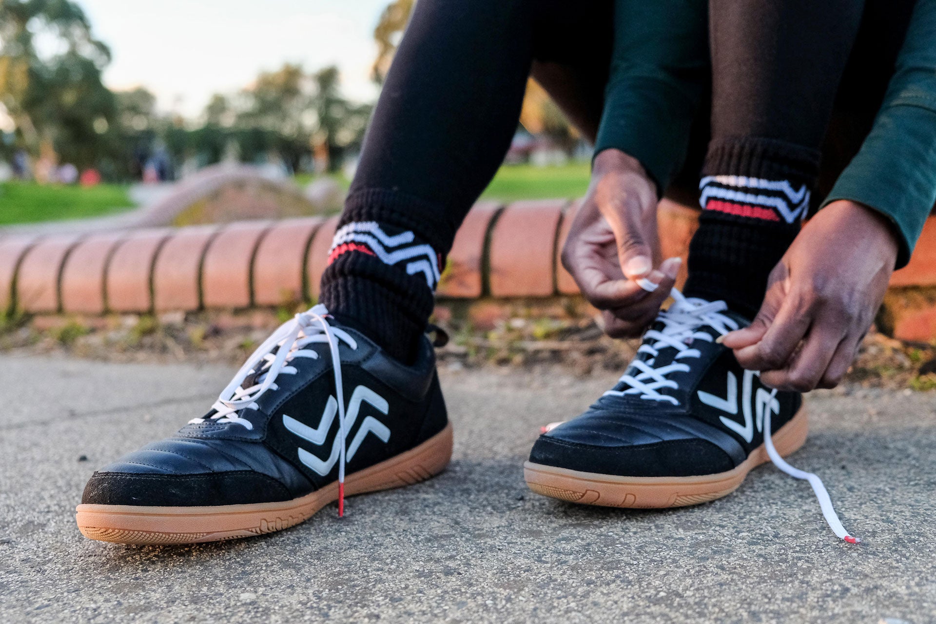 Tying shoelaces on black futsal shoes