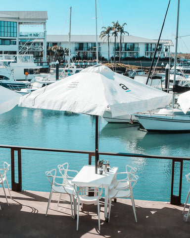 A dining table located right beside the water at Port Macquarie Marina